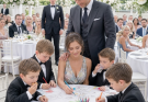 My brother sent me to the kids’ table at his wedding and quietly said, “Don’t embarrass us.” I smiled and took my seat. Minutes later, the billionaire guest he’d spent months trying to impress ignored the head table and sat down right beside me.